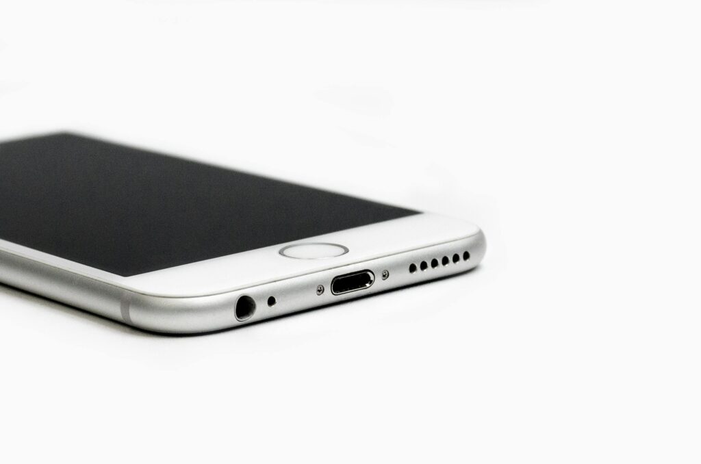 Close-up view of a smartphone on a white background, highlighting mobile devices that benefit from signal boosters for stronger connectivity.